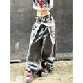 Women's grey distressed baggy denim jeans in a Y2k gothic style with oversized fit and graphic print.