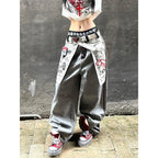 Women's grey distressed baggy denim jeans in a Y2k gothic style with oversized fit and graphic print.