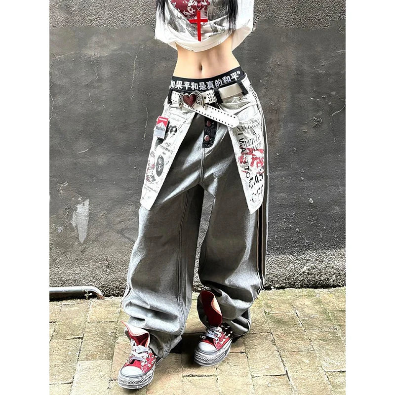 Women's grey distressed baggy denim jeans in a Y2k gothic style with oversized fit and graphic print.