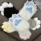 Furry animal claw mittens in white, black, and grey with blue, pink, and yellow paw pads.