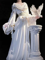 White ethnic style A-line ankle-length dress with ruffles, gold trim, and wide sleeves.