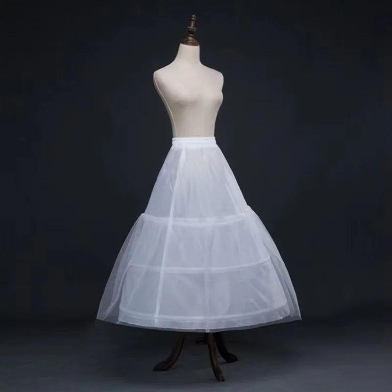 White three-hoop petticoat skirt on a mannequin, featuring tiered tulle layers for dress volume.